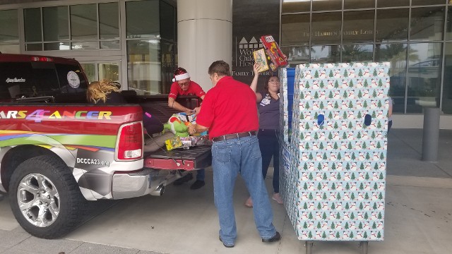 Red Pick-up Truck and the Man Unloading the Gifts